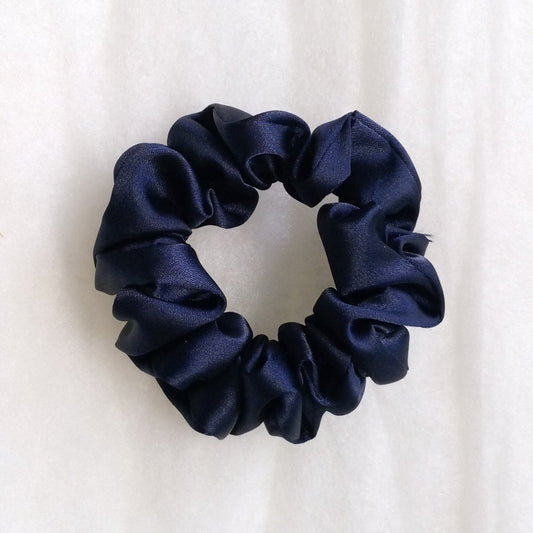 Navy blue scrunchie on a white background